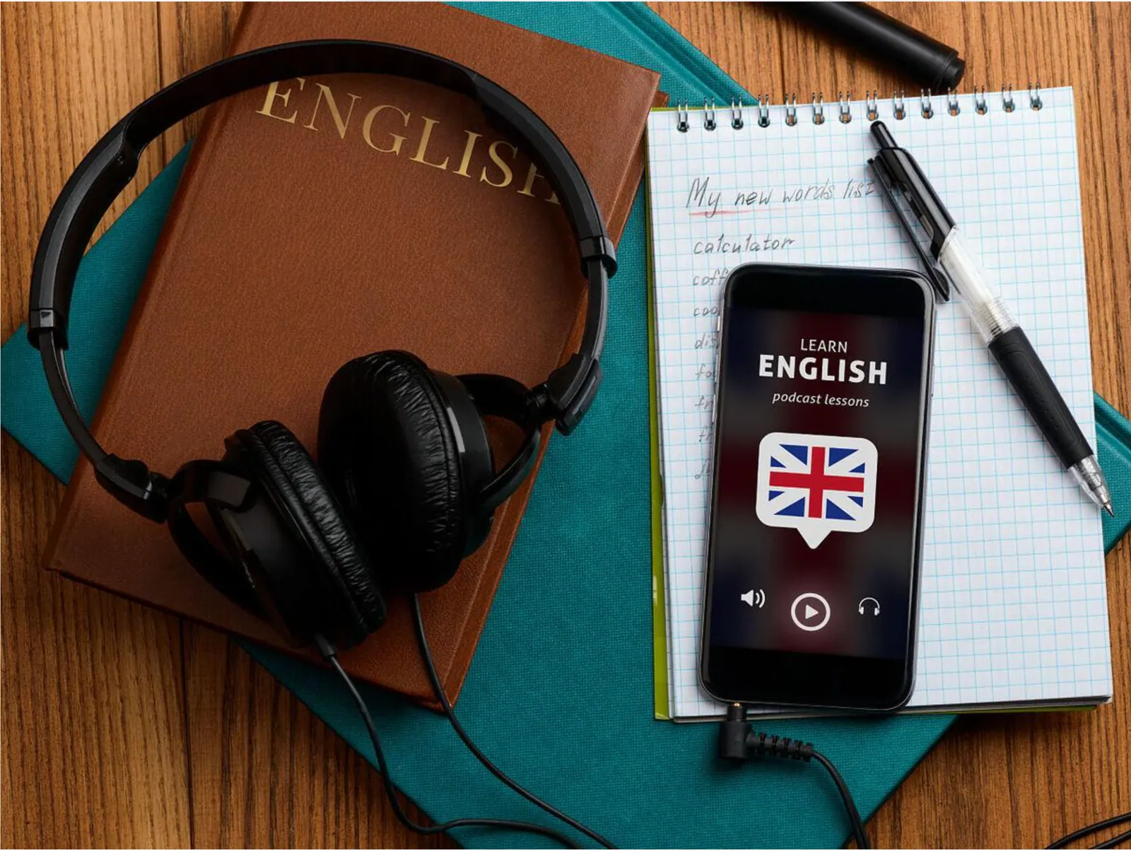 Cuffie, quaderno e lezione audio per esercitarsi con l'inglese parlato